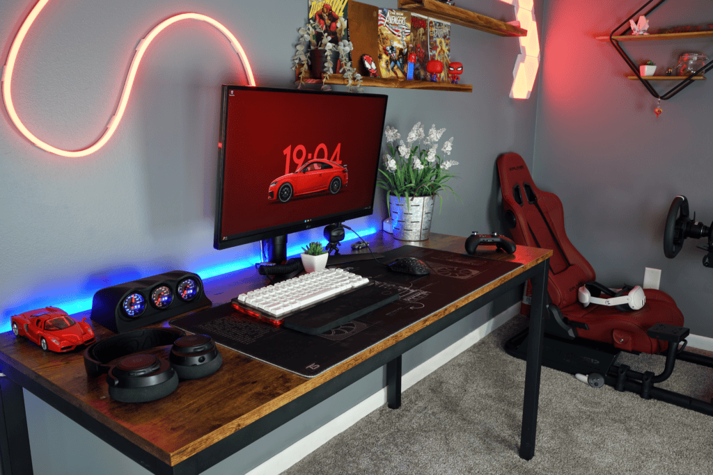 Tech gaming and work setup with LED lighting and ergonomic chair.