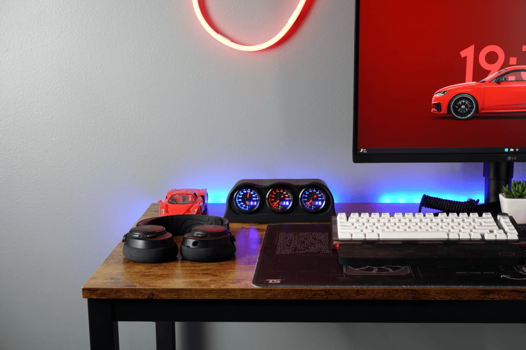 Modern gaming and tech workspace featuring Lumen Dash Founder's Edition, gaming accessories, and a sleek monitor with ambient lighting for an immersive experience.